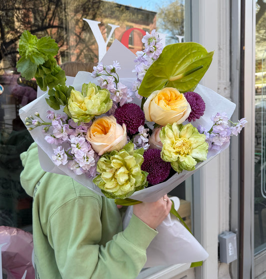 “Lavender Citrus Harmony” (Anthurium, garden roses, chrysanthemum, veggie rose, stocks, bells of Ireland)